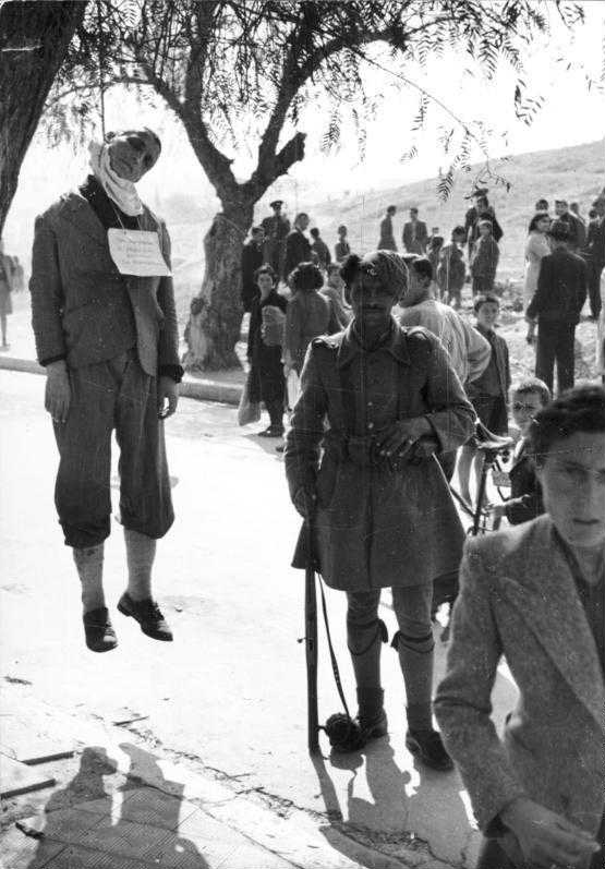 Член Батальона безопасности рядом с казненным греком, 1943 г. Источник: Deutsches Bundesarchiv.