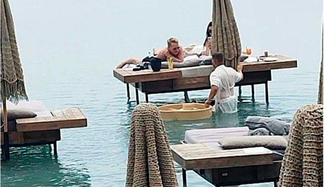 Rhodes: scandal surrounding waiter serving sun loungers in the sea